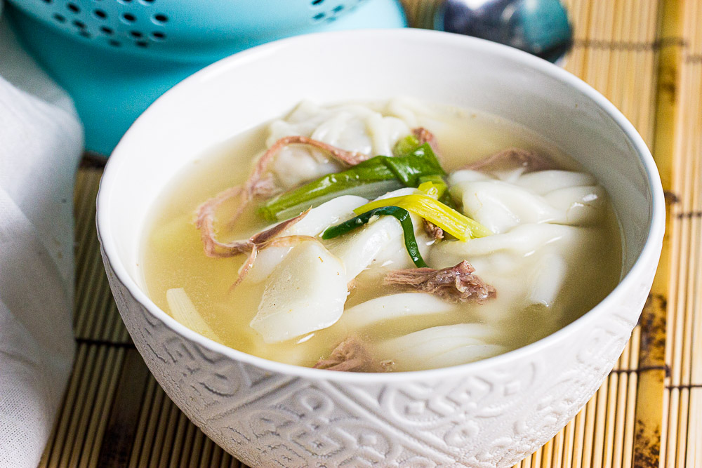 Korean rice cake soup with dumpling (Tteok Mandu Guk) is a soothing and hearty soup. The clear broth signifies purity and the rice cakes symbolize prosperity.