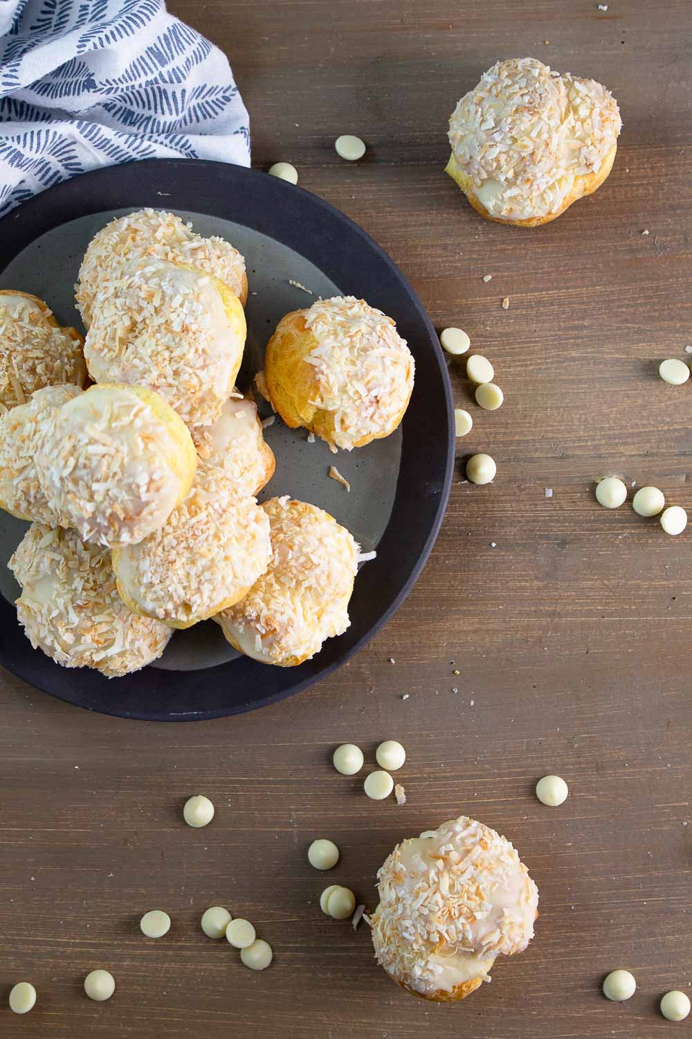 If you love cream puffs, put these orange coconut cream puffs on your to-do list. This homemade cream puffs recipe is made with a classic French choux pastry dough and filled with orange coconut cream and drizzled with white chocolate ganache. Perfect for your sweet tooth cravings.