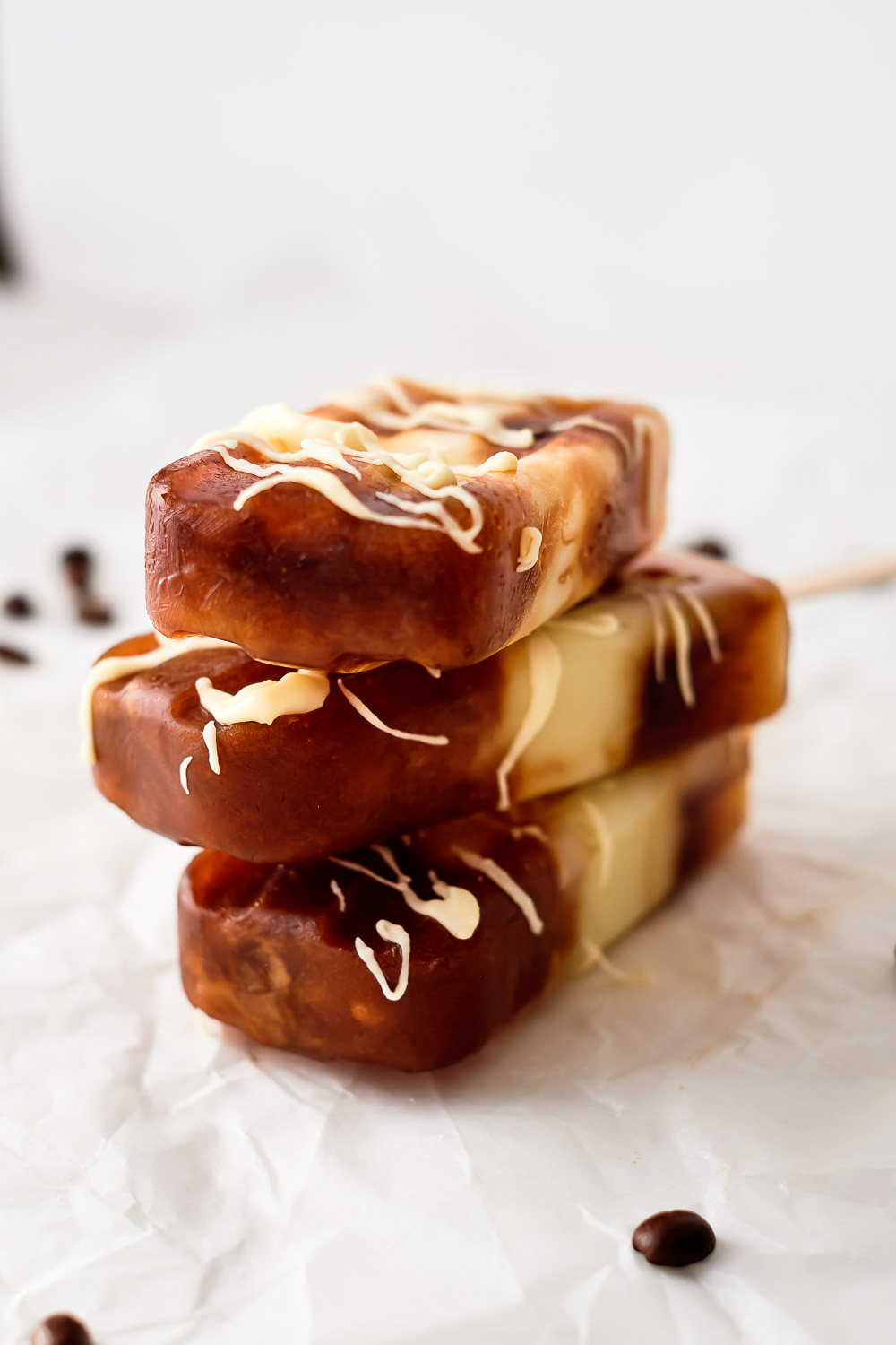 Get ready for the warmer weather with these white chocolate mocha popsicles. These popsicles make the perfect dessert for summer or any time. For a delicious, cooling dessert, always have extra of these popsicles in the freezer at all times.