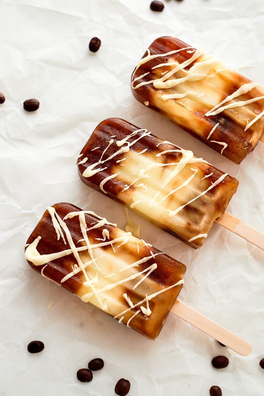Get ready for the warmer weather with these white chocolate mocha popsicles. These popsicles make the perfect dessert for summer or any time. For a delicious, cooling dessert, always have extra of these popsicles in the freezer at all times.