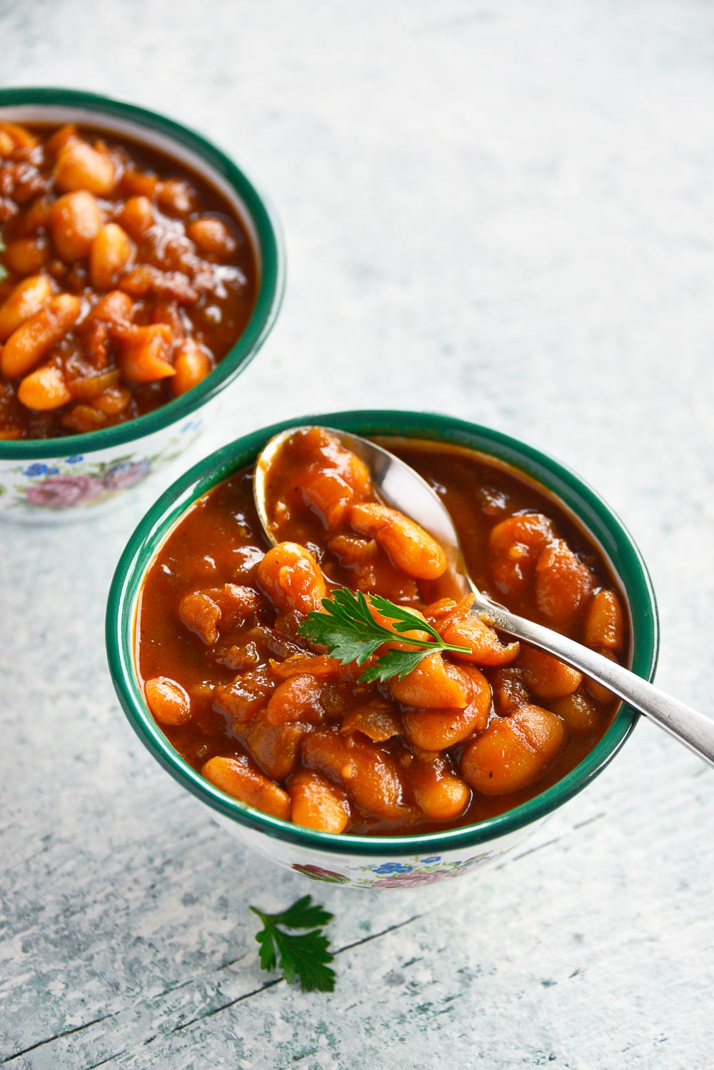 Homemade maple baked beans with bacon is a classic recipe that you can enjoy throughout the year. Sweet and smoky, these baked beans are so tender, easy to make, and can be easily adapted for your meatless Monday lineup. Learn how to cook this flavorful dish in 3 different ways - Dutch oven, slow cooker, Instant Pot. 