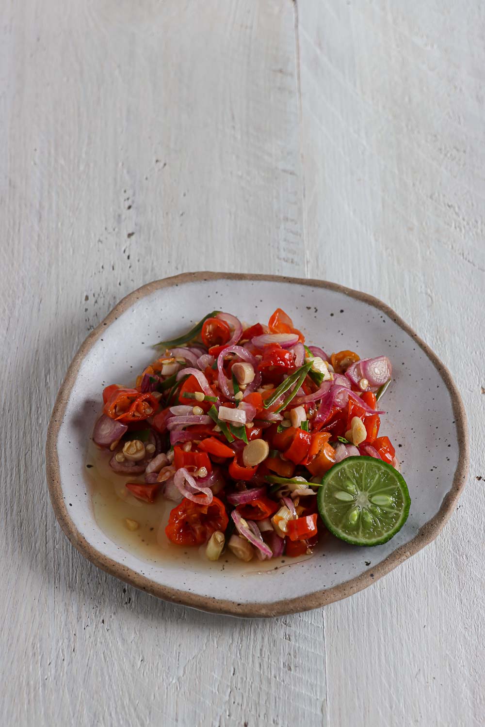 Learn the easy way to make Balinese sambal matah or raw Balinese shallot and lemongrass relish at home. Healthy, simple, and flavorful.