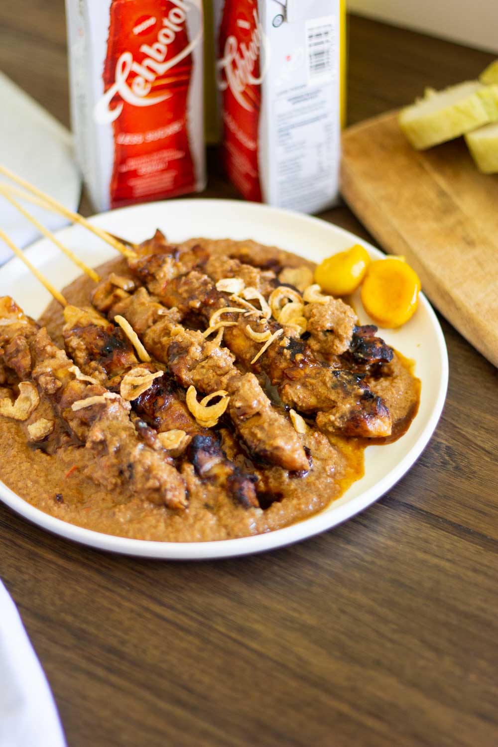 These Indonesian grilled chicken skewers (sate ayam Madura) with homemade sauce are tender, juicy, flavorful, and perfect for the summer grilling season. Learn how to make authentic Indonesian sate ayam (chicken satay) served with peanut sauce that you want to drizzle on everything.