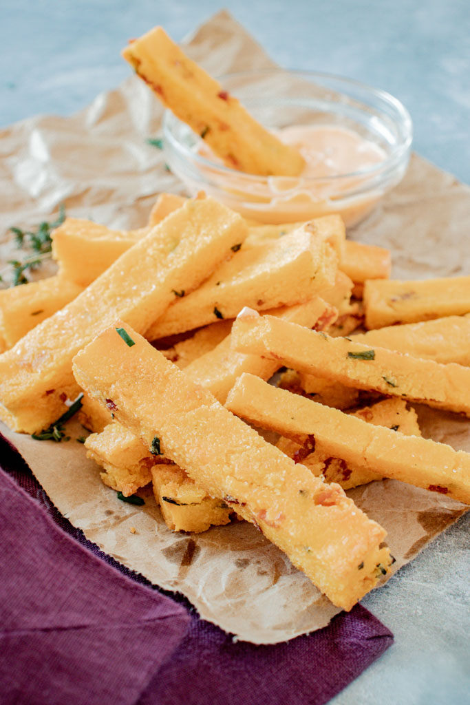 Golden baked cheddar bacon polenta fries with smoky chipotle aioli dip