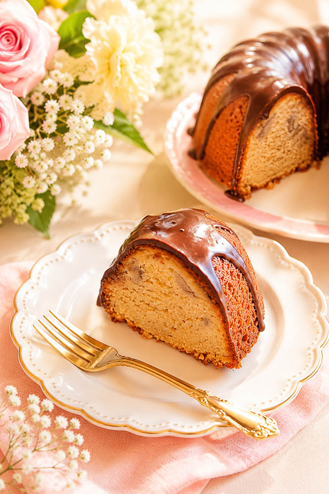 This moist Banana Bourbon Bundt Cake combines ripe bananas and bourbon with a rich dark chocolate ganache for an easy, decadent dessert