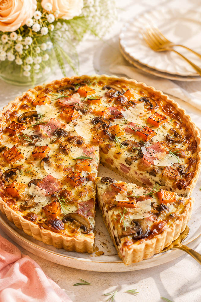 This savory Butternut Squash Pie combines sweet roasted squash, smoky ham, mushrooms, Parmesan, and rosemary in a flaky golden crust.