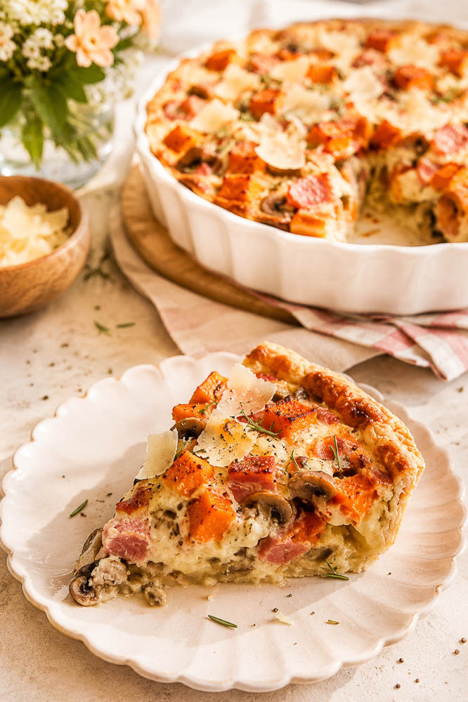 This savory Butternut Squash Pie combines sweet roasted squash, smoky ham, mushrooms, Parmesan, and rosemary in a flaky golden crust.
