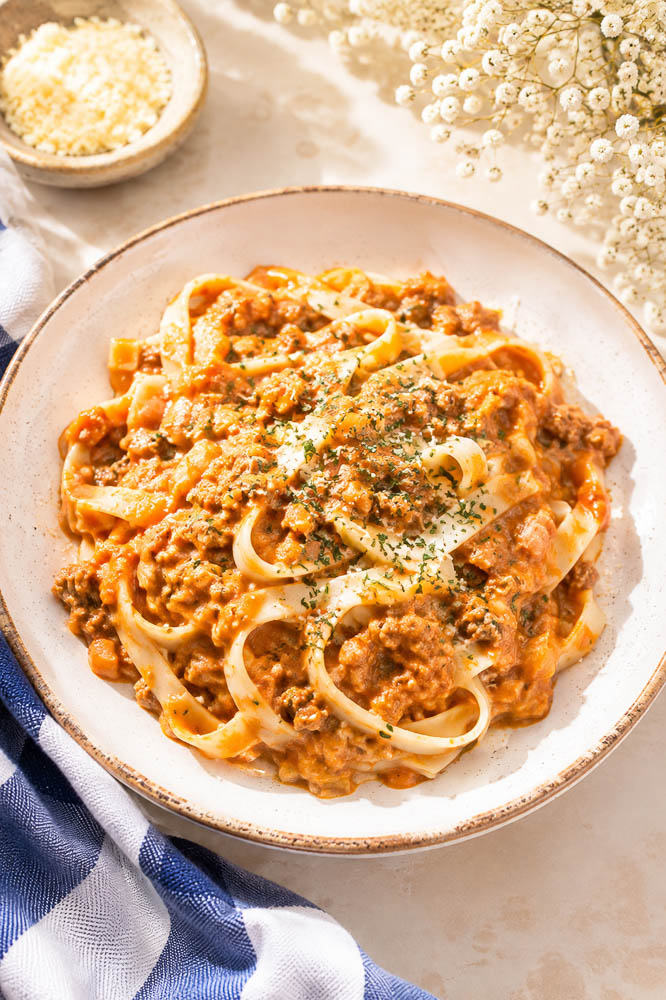 This Creamy Pumpkin Pasta combines savory ground beef, pumpkin, tomato, Parmesan, and cream in a rich, cozy sauce that comes together in about 30 minutes.