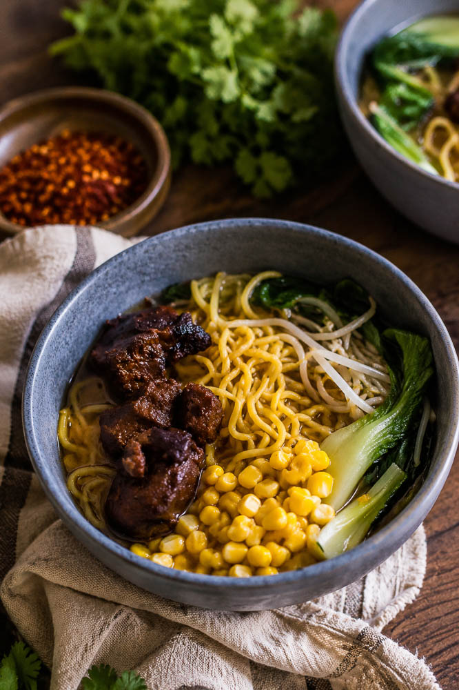 This Crockpot Caramelized Pork Noodle Soup combines fall-apart pork shoulder, a rich savory broth, tender noodles, and crispy-edged caramelized pork in one seriously cozy bowl.