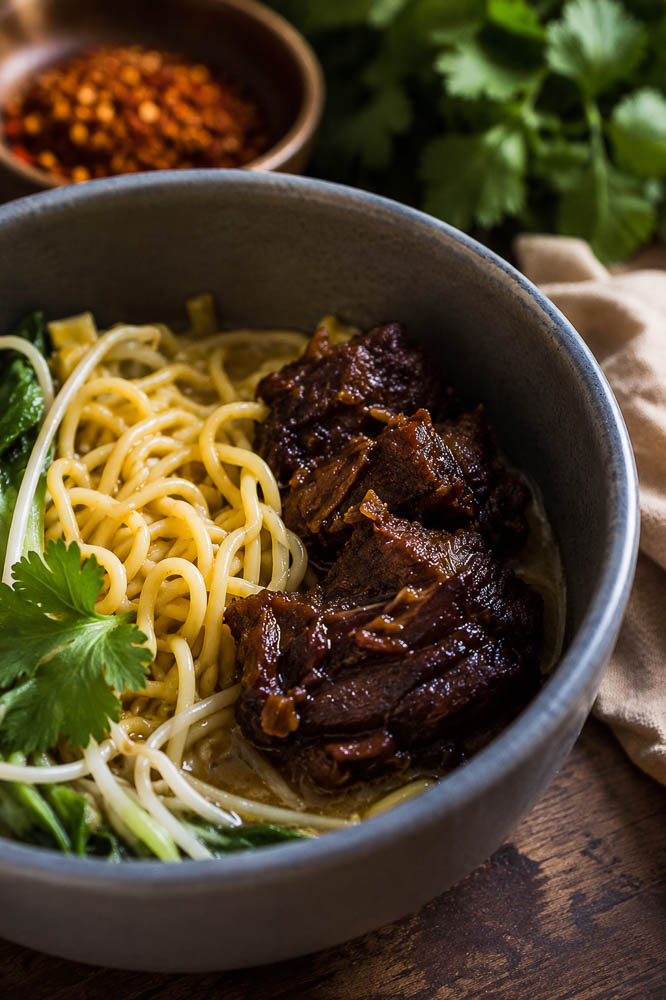 This Crockpot Caramelized Pork Noodle Soup combines fall-apart pork shoulder, a rich savory broth, tender noodles, and crispy-edged caramelized pork in one seriously cozy bowl.