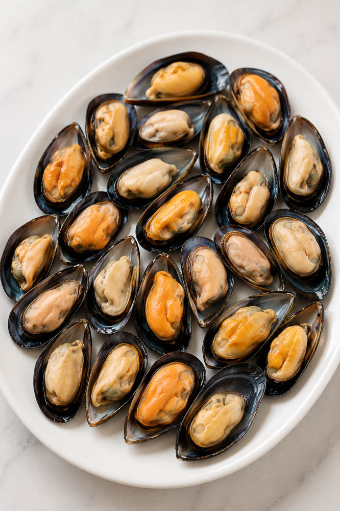 These Jimbaran-Style Grilled Mussels are topped with a buttery garlic sauce that’s sweet, savory, and slightly tangy, then broiled until the edges are bubbling and beautifully caramelized.