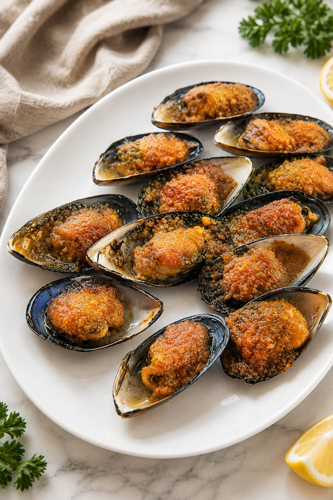 These Jimbaran-Style Grilled Mussels are topped with a buttery garlic sauce that’s sweet, savory, and slightly tangy, then broiled until the edges are bubbling and beautifully caramelized.