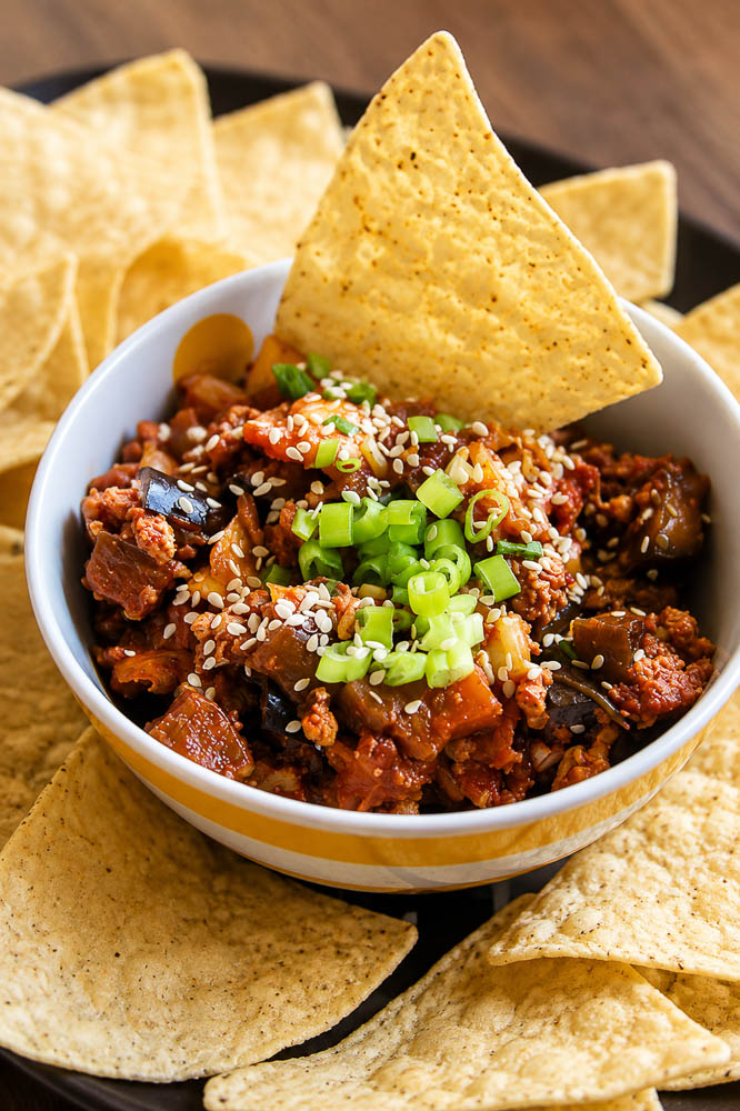 These Kimchi Eggplant Nachos pile crispy tortilla chips with savory ground pork, tender eggplant, and spicy, tangy kimchi for a Korean-inspired appetizer that is loaded with flavor and texture.
