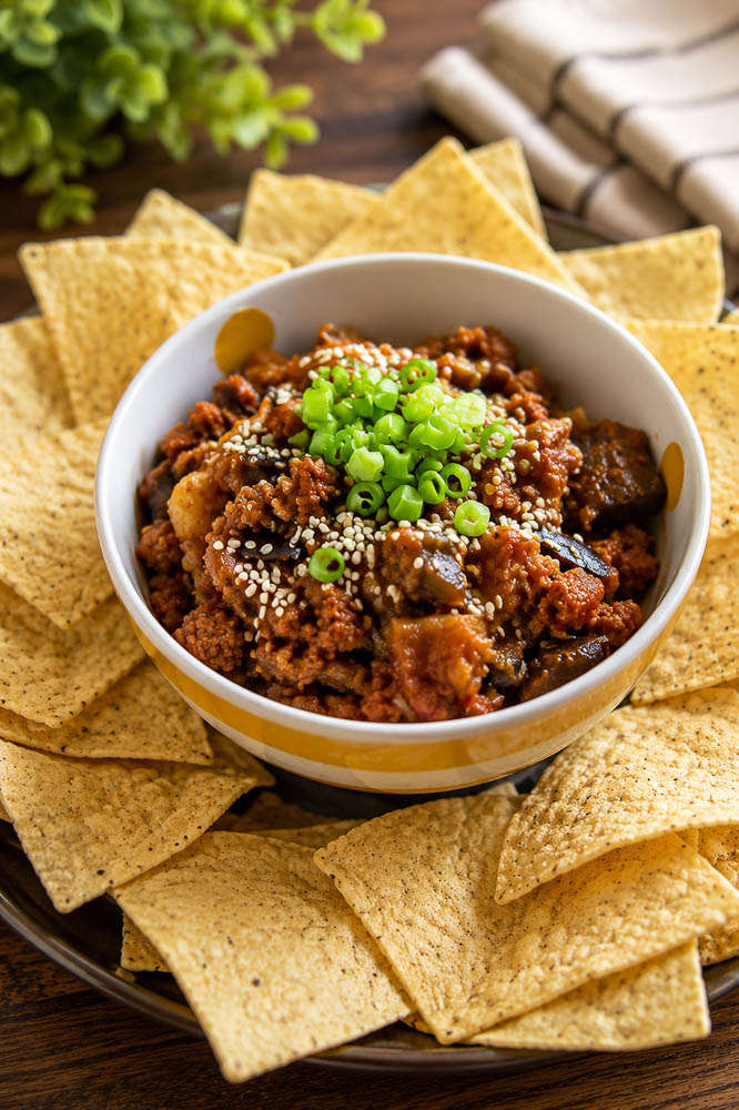 These Kimchi Eggplant Nachos pile crispy tortilla chips with savory ground pork, tender eggplant, and spicy, tangy kimchi for a Korean-inspired appetizer that is loaded with flavor and texture.