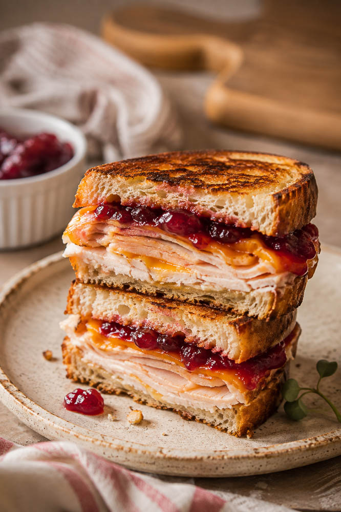 Turn leftover turkey into a crispy grilled cheese with melty cheddar and Gouda plus tangy cranberry sauce. An easy holiday leftover sandwich!