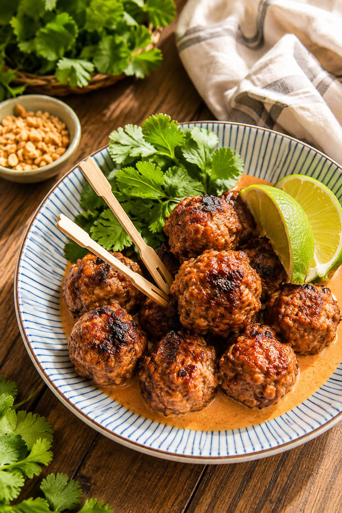 These Saucy Thai Meatballs are juicy, savory, and packed with lemongrass, lime, garlic, fish sauce, and red curry, then finished in a creamy coconut curry sauce that begs to be spooned over rice.